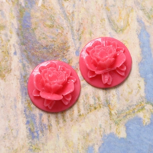 Close-up of pink resin rose petal cabochon charms for DIY jewelry and hair accessories