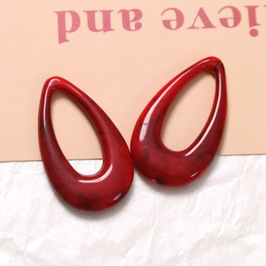 Detail of red marble texture resin hollow waterdrop charms for DIY jewelry making
