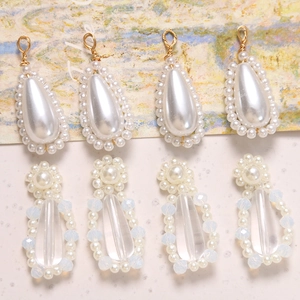 DIY handmade jewelry charms with pearl teardrops and golden wire hooks for earrings