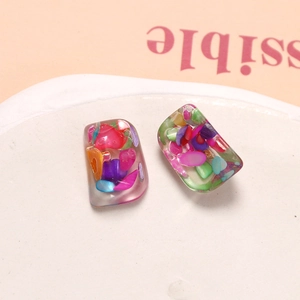 Detailed close-up of rectangular resin charms with colorful crushed stone inlay