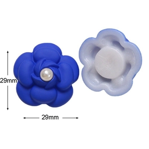 Detail view of 29mm blue resin camellia flower charms with pearl center for DIY crafts
