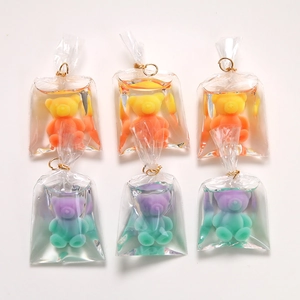 Macro shot of cute gradient bear charms in transparent liquid bags for DIY crafts