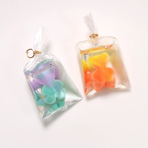 Macro shot of bear pendant charms with colorful liquid filling in transparent bags