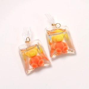 Detail view of cute 3D resin bear charms in transparent water bags with gold rings