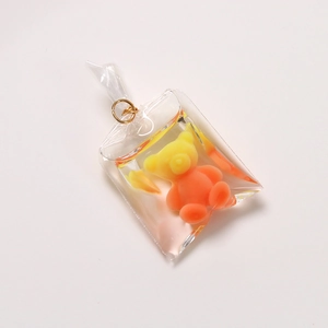 Detail of gradient resin bear charm sealed in a clear transparent bag-shaped shell