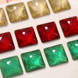 Macro detail of square resin cabochons with silk-like gold wire texture for DIY jewelry