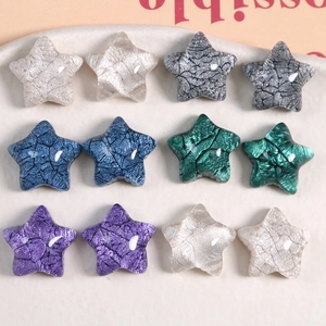 Macro shot of 12 resin star charms with marble texture for DIY jewelry and crafts
