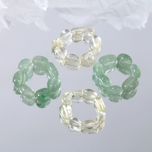Handmade stretch rings set with natural oval stone beads in green and yellow hues