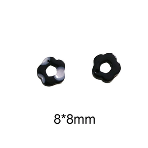 Detalle macro de cuentas de flores de resina de 8mm con mármol blanco y negro para DIY