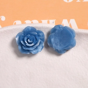 Macro detail of 22mm blue ink-wash resin rose charms with flat back for DIY crafts