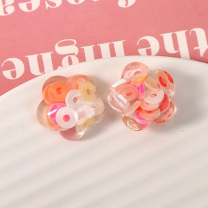 Macro view of transparent flower resin charms with colorful inner ring patterns for DIY crafts