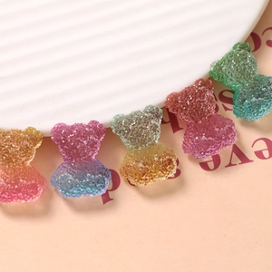 Macro shot of colorful gradient resin bear charms with sugar texture for DIY crafts