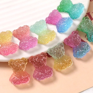 Close-up of colorful gradient resin bear charms with sugar texture for DIY jewelry making