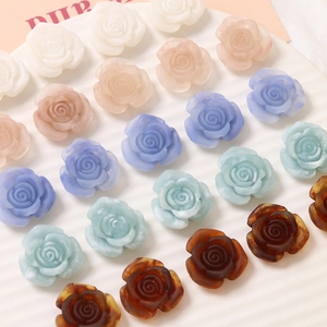 Close-up of matte resin rose flower charms in pastel colors for DIY jewelry making