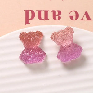 Macro detail of gummy bear resin charms with sugar coating texture and pink purple gradient