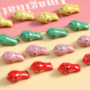 Bunte 3D Koi-Fisch Keramikperlen für DIY Schmuckherstellung auf buntem Hintergrund
