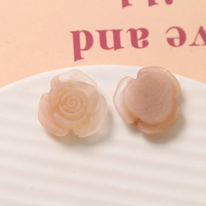 Detailed front and back views of matte peach resin rose charms for DIY jewelry making