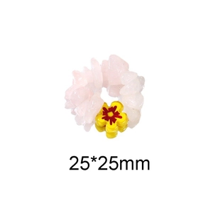 Detailed macro view of a handmade ring featuring pink crushed stones and a yellow flower