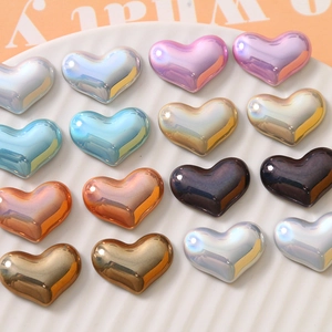 Macro detail of colorful metallic heart-shaped resin charms with iridescent aurora glow