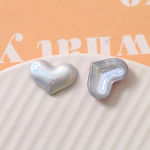 Macro detail of iridescent heart-shaped pearl beads for DIY jewelry and crafts