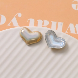Close-up of heart-shaped pearl beads with iridescent coating for DIY jewelry making
