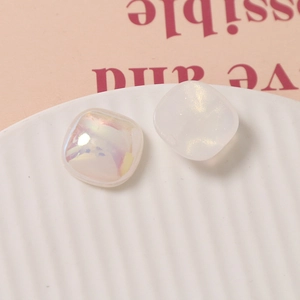Macro view of 18mm iridescent and pearlescent square cabochons for DIY jewelry making
