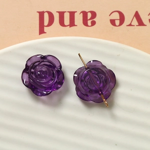 Détail de breloques roses en résine violette transparente avec tige en métal doré
