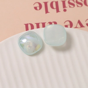 Macro shot of 18mm light blue iridescent square resin charms for DIY jewelry making