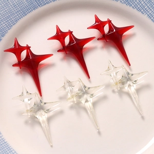 Red and transparent resin star charms in various sizes for DIY craft jewelry making