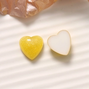 Detail of 16mm heart resin charms with gold glitter yellow and creamy white finish
