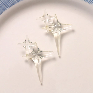 Close-up of transparent resin four-pointed star charms for DIY jewelry and hair accessories