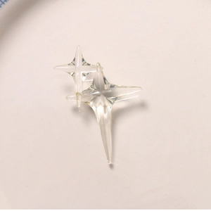 Macro shot of two transparent resin four-pointed star charms for jewelry making