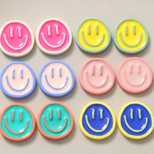 Macro detail of colorful 3D smiley face resin charms for DIY jewelry and crafts