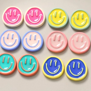 Detailed view of colorful resin smiley face charms for DIY jewelry and accessories
