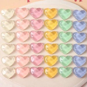 Macro shot of 36 colorful heart-shaped resin charms with wavy facets and matte finish