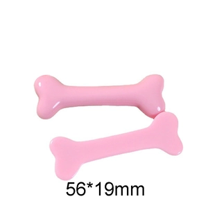 Detail view of two pink glossy resin bone accessories with dimensions 56x19mm for DIY crafts