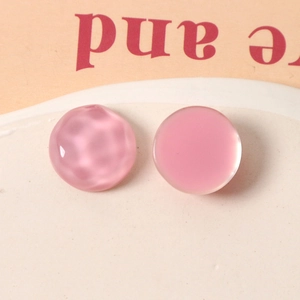 Detail of 16mm pink resin geometric charms with smooth and ripple textures for DIY jewelry