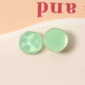 Detailed view of light green 16mm water ripple resin beads for DIY jewelry making