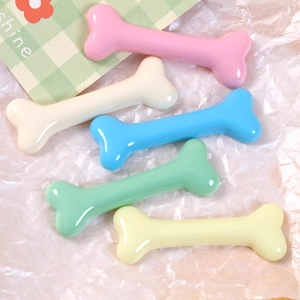 Close-up of glossy macaron resin bone charms for DIY hairpins and accessories in 5 colors