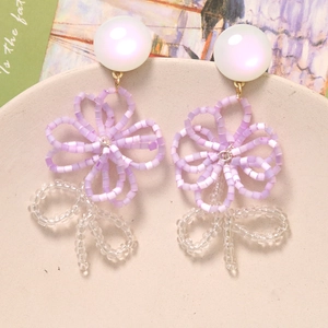 Handmade 16mm purple beaded flower earrings with white resin top and iridescent finish
