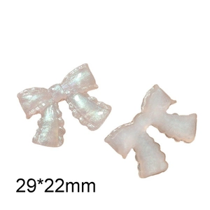 Close-up of pink glitter bow resin charm with pearlescent texture for DIY projects, 29x22mm