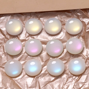 Macro detail of 16mm round iridescent AB cat eye opal patches for DIY jewelry making