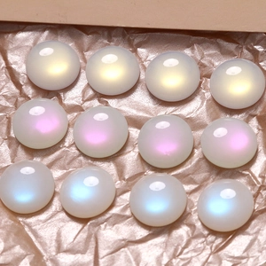 Macro view of 16mm iridescent ab cat eye cabochons in yellow, pink and blue tones