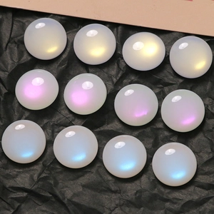 Macro view of 16mm iridescent faux opal flatback cabochons with colorful rainbow gloss