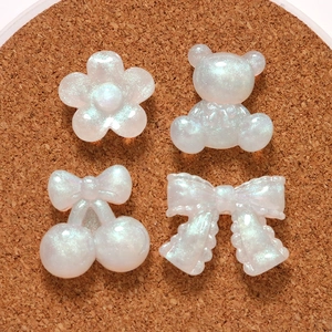 Pearlescent white resin DIY charms in bear and flower shapes with glitter finish