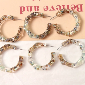 Three pairs of C-shaped resin earrings with colorful shell fragments in artistic terrazzo style