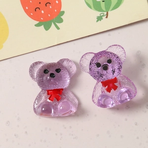 Detailed view of purple resin teddy bears with red bowties for DIY jewelry making