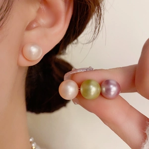 Detailed close-up of s925 silver needle pearl studs in white pink blue and purple tones