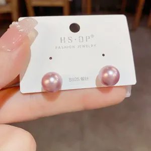 Detailed close-up of 8-10mm pink pearl stud earrings with S925 sterling silver pins