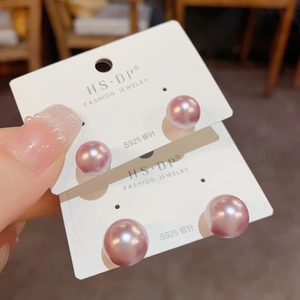 Detailed close-up of light purple pearl stud earrings with S925 sterling silver needles